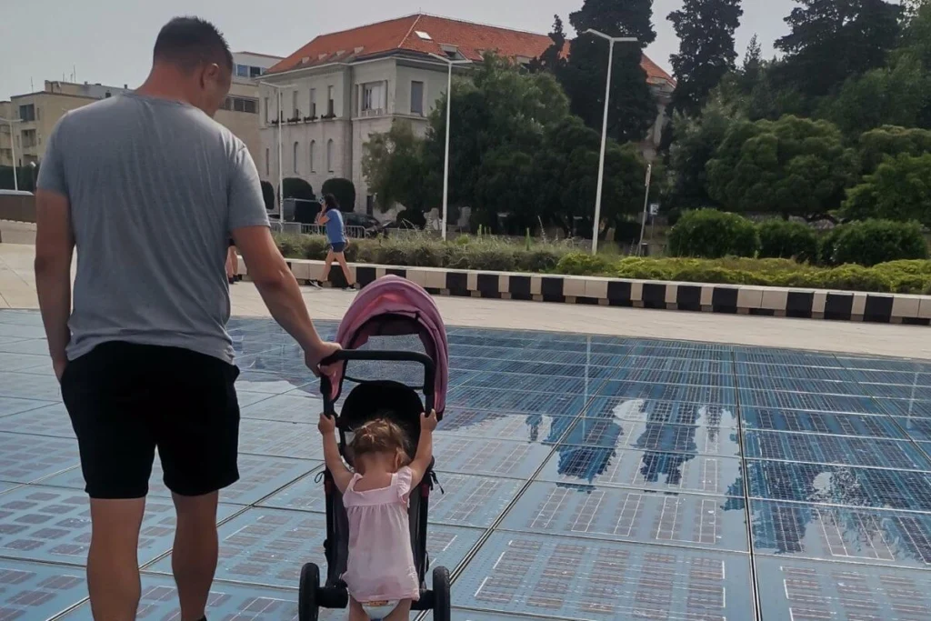 The Greeting to the Sun solar installation in Zadar, Croatia, on a wide, flat stone promenade, perfectly accessible for strollers and wheelchairs during the famous sunset.