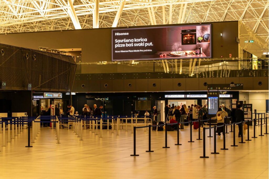 Modern check-in and departure hall at Franjo Tuđman Zagreb Airport for families traveling to Croatia