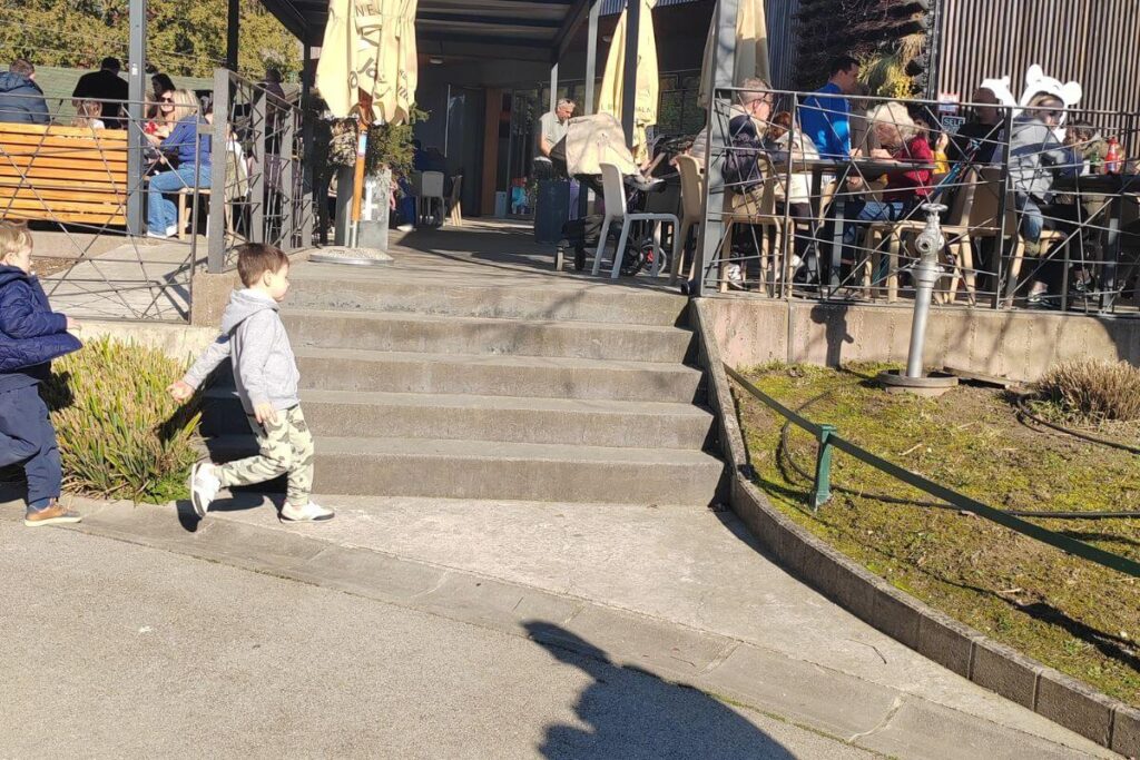 Children playing near the outdoor terrace of the restaurant at Zagreb Zoo.