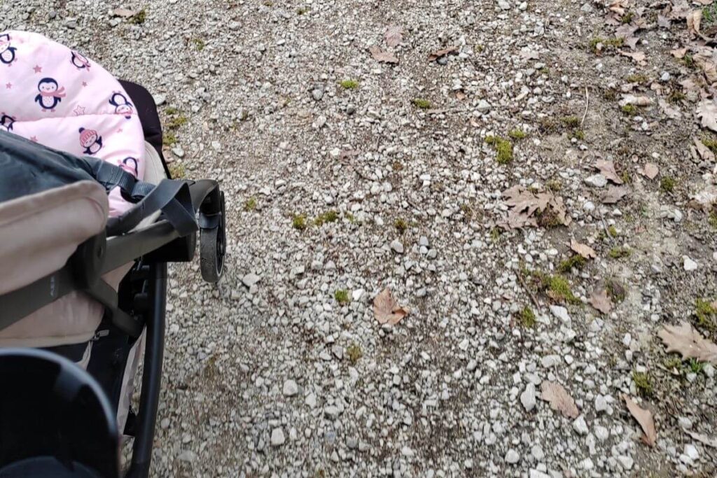 (Stroller on gravel)A baby stroller on a gravel path in Grad Mladih park Zagreb.