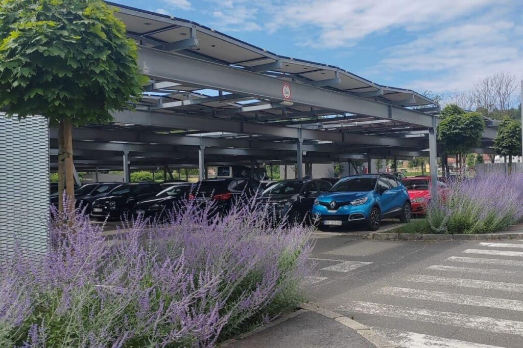 Covered parking lot with solar panel canopy and parked cars at Terme Tuhelj.