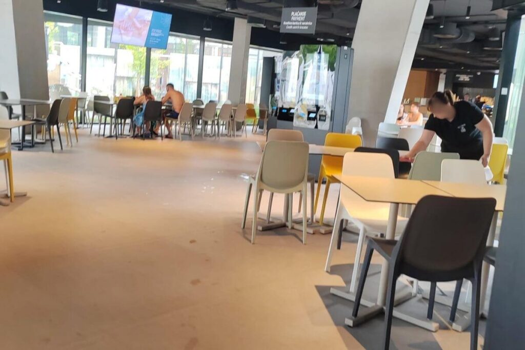 Modern indoor restaurant seating area inside Terme Tuhelj featuring ample table seating, wide walkways, and self-service counters.