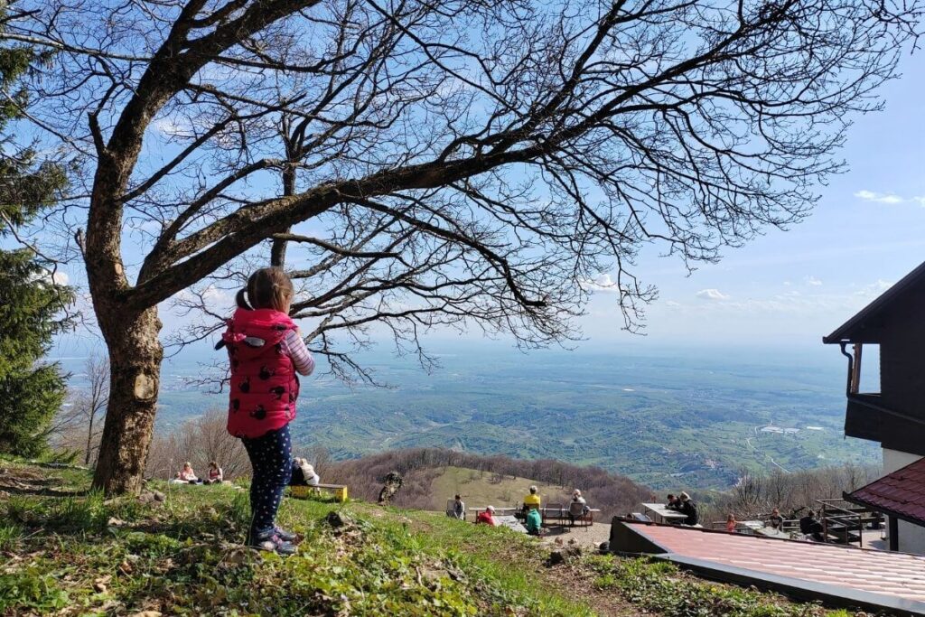 Young girl enjoying the sweeping landscape view from Planinarski dom Zitnica on Japetic